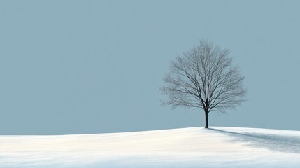 Fototapeta premium A Single Bare Tree Standing on a Snowy Hill Against a Pale Blue Sky
