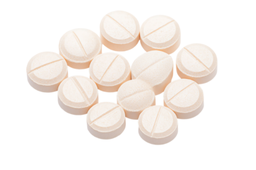 Close-up of assorted beige tablets arranged on a white background, ideal for health, medicine, and pharmaceutical themes.