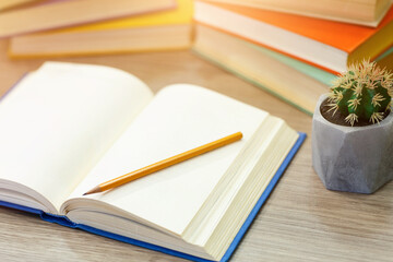 Time To Study. Open notebook lying on wooden desk with pencil on paper, high angle view