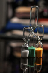 Tiny yellow , green hourglass with delicate sand, measuring moments with a pop of color