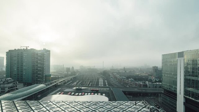 Time lapse of The Hague central train station at sunrise with trains, busses and metro arriving and departing