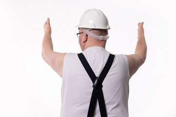 A construction worker in safety gear, confidently raising both arms, symbolizes teamwork