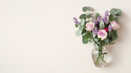 Obraz premium A vase with pink and purple flowers sits atop a white wall, alongside a lush green plant