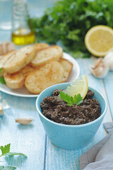 A bowl with tapenade - traditional olive dip in Mediterranean region