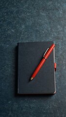 Closed notebook with pen on a blue table