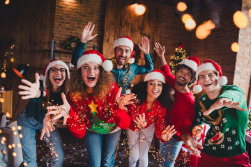 Photo of cheerful young people friends group have fun dance wave hand cheerful smile cozy christmas...