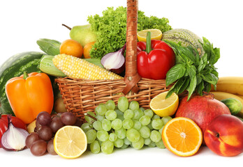 Different fresh fruits and vegetables in wicker basket isolated on white