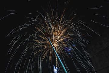 An impressive fireworks display captured at night, with golden and silver streaks radiating against...