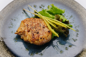 Juicy grilled chicken fillet with fresh salad leaves, perfect for a healthy and delicious meal