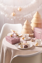 Wonderful table set for Christmas with tableware full of presents.