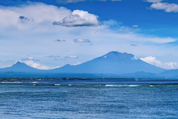 Mount Agung volcano view from Sanur Beach Bali Indonesia, clear skies, daytime,