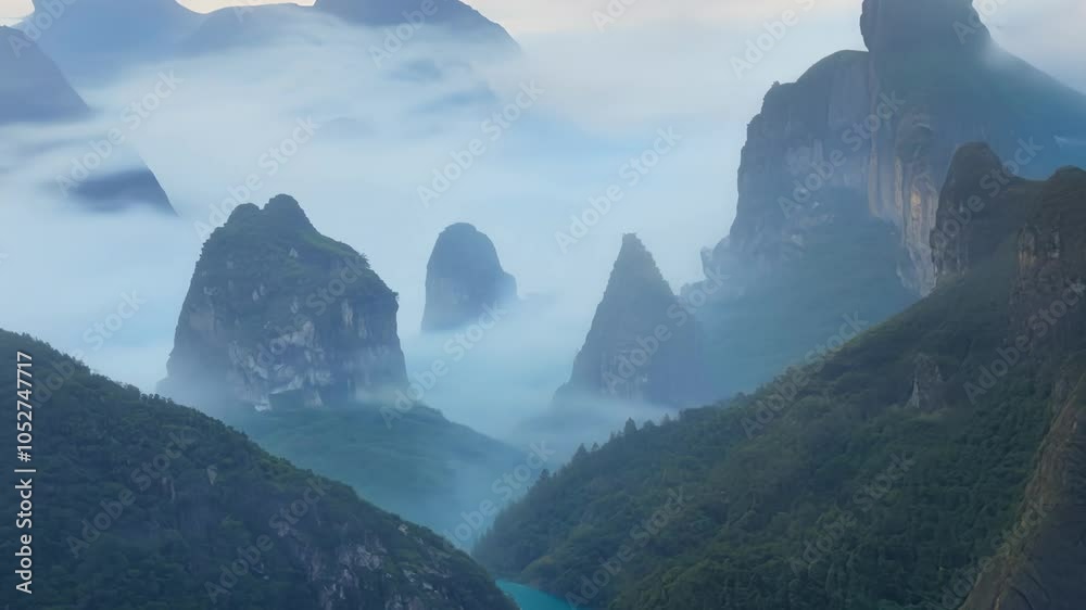 Poster Surreal landscapes showcase a valley surrounded by steep mountains and dense fog, creating a mysterious atmosphere that captivates with its ethereal beauty