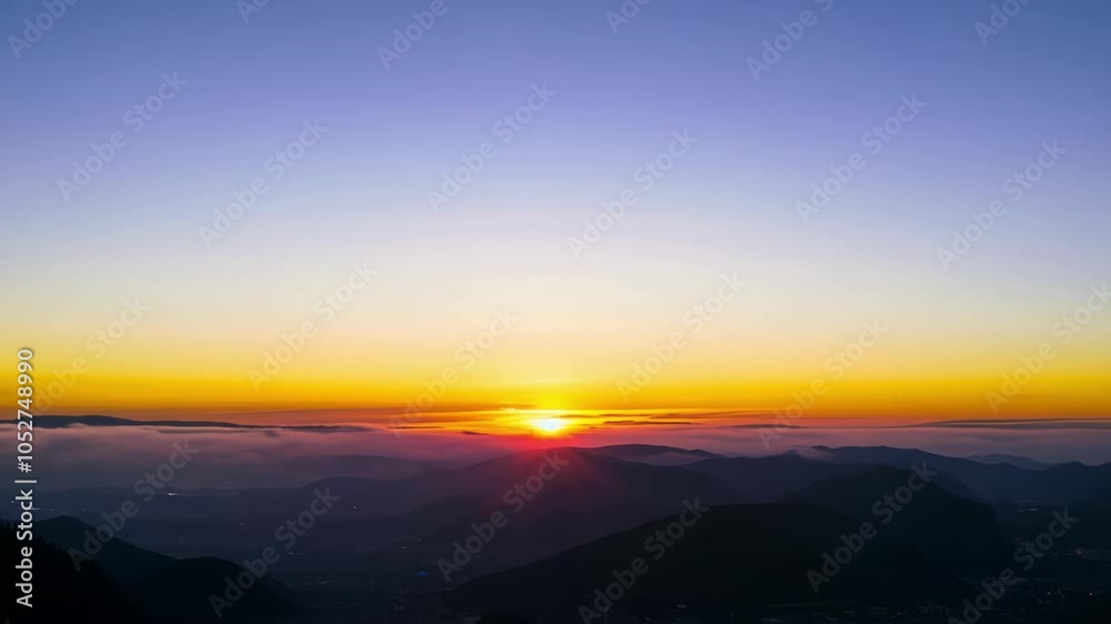 Poster sun rising above a sea of clouds creating a surreal gradient. the sky shifts from deep blue to vibra