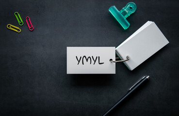There is word card with the word YMYL. It is an abbreviation for Your Money or Your Life as...