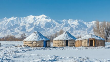 Snowy Landscape with Traditional Yurts and Mountains