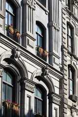 Beautiful historic stone architecture with flowers on window sill in Old Montreal