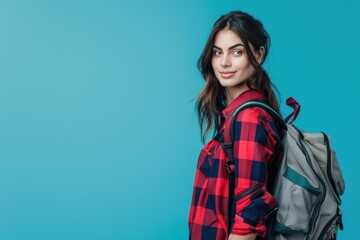 Fototapeta premium Beautiful lady with travel bag, ready for adventure, solid color background