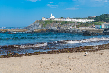 View from the beach of the chapel and the cemetery of the town of Luarca, Spain