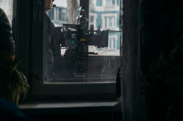 Professional film and video camera on the set. Shooting shift, equipment and group.