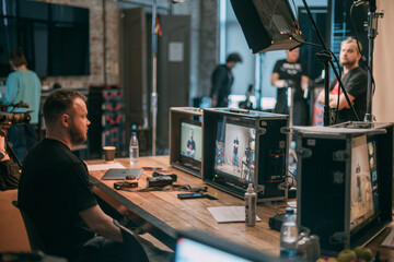 Director at work on the set. The director works with a group or with a playback while filming a...