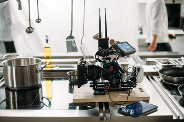 Professional cinema and video camera on the set. Shooting shift, lighting fixtures, shooting equipment and the team. Technique of modern filming and advertising.