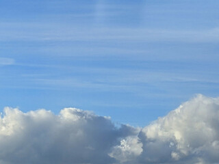 Big White Fluffy Clouds on A Blue Sky With Fine Whispy Lines