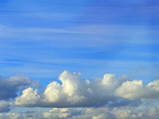 Big White Fluffy Clouds on A Blue Sky With Fine Whispy Lines