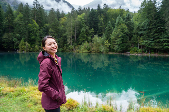 Young asian woman enjoying the beauty of Blausee, Switzerland