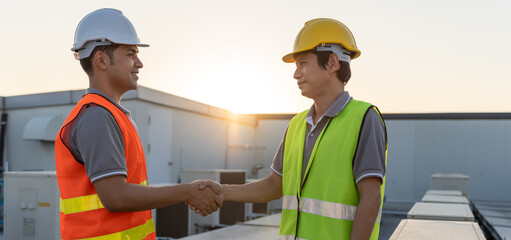 Engineers team shake hand after install air condition systems on site. Contractor and inspector...