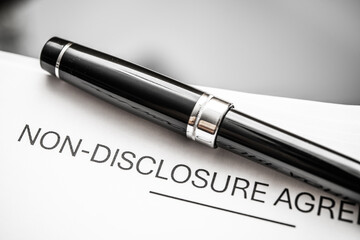 Elegant Black Pen on Non-Disclosure Agreement Document, Representing Confidentiality, Business Contracts, and Legal Obligations in Corporate Settings