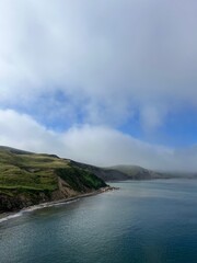 rocky cliff surrounded by clouds