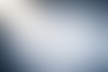 A blurry image of a blue sky with a sun shining through the clouds. Noisy background with grain