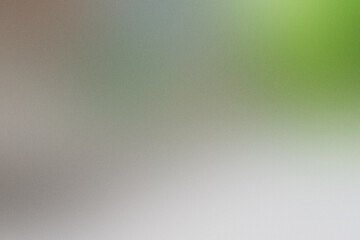 Obraz premium A blurry image of a green and gray background with a green leaf. Noisy backdrop with grain