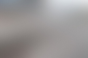 A blurry image of a silver surface with a grainy texture. Noisy backdrop with grain