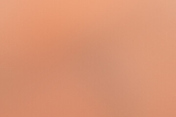 A tan background with a blurry orange line. Noisy backdrop with grain