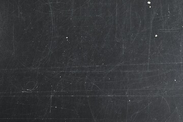 Texture of scratched black surface as background, closeup