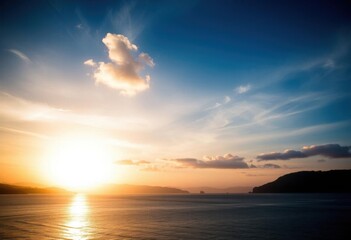 Fototapeta premium a sunset over the ocean with a boat in the distance