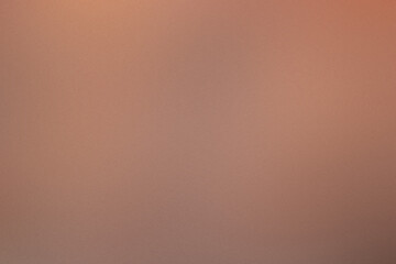 A brown background with a blurry image of a person. Noisy backdrop with grain