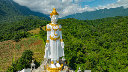 Big Buddha Brahma Panyo standing tall in front of Doi Luang mountain, Chiang Mai symbolizing peace...