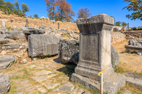 A stone pillar with a plaque on it sits in a field. August 7, 2024 Philippi Greece