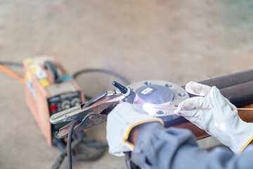 The technician is welding the flange assembly with argon.