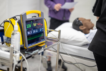 Simulated patient mannequin in hospital bed, health care setting, simulated hospital room, virtual...