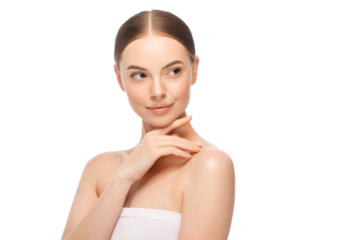 Young beautiful female pictured after having shower, wrapped in towel, touching chin with finger, looking away