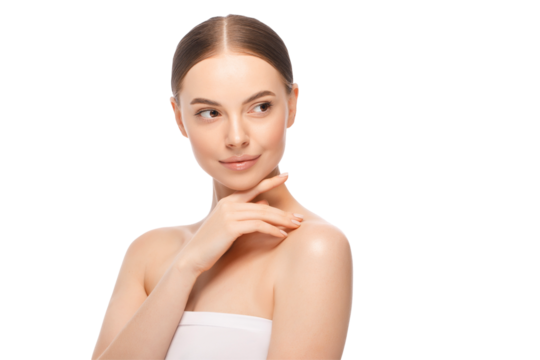Young beautiful female pictured after having shower, wrapped in towel, touching chin with finger, looking away