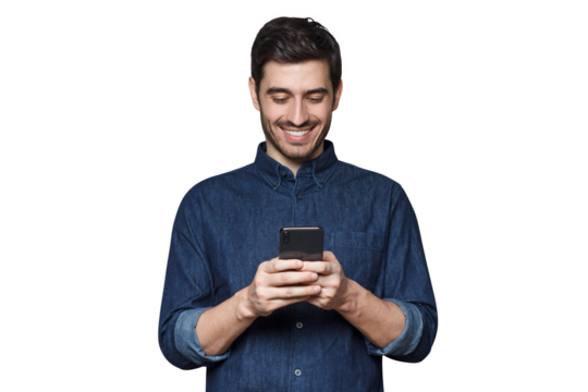 Smiiling business man in denim shirt and trendy glasses typing a message using his phone