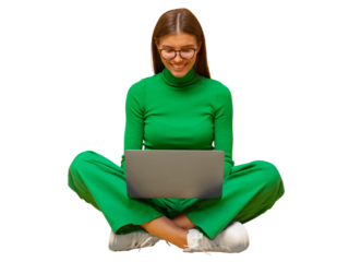 Portrait of woman in green clothes sitting on floor with laptop on knees