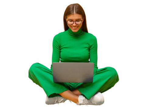 Portrait of woman in green clothes sitting on floor with laptop on knees