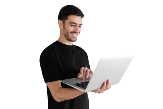 Young handsome man standing, holding laptop and watching media with smile, sharing web content