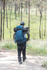 Fototapeta premium Man hiker relaxing on mountain nature landscape standing mountain outdoor adventure and leisure travel and relaxing destination in nature park vacation travel