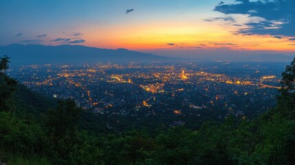 Obraz premium Panoramic view of a city at sunset, with distant mountains and a hazy sky.